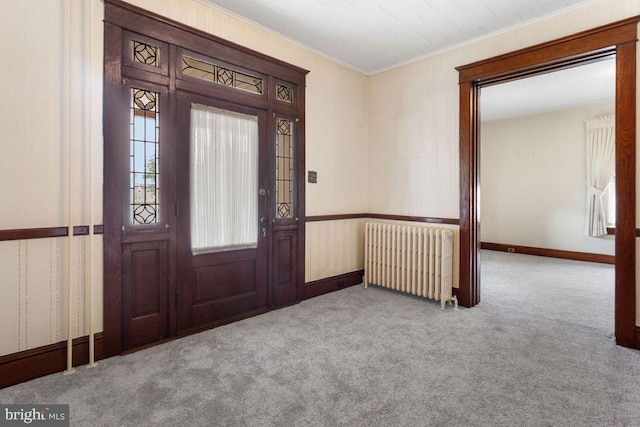 31 4th St, Hanover, PA 17331 - entrance foyer with radiator heating unit, carpet flooring, and ornamental molding