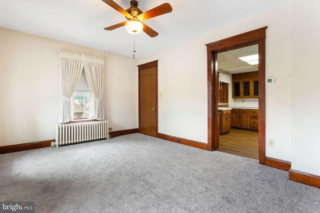 31 4th St, Hanover, PA 17331 - carpeted empty room with radiator and a ceiling fan