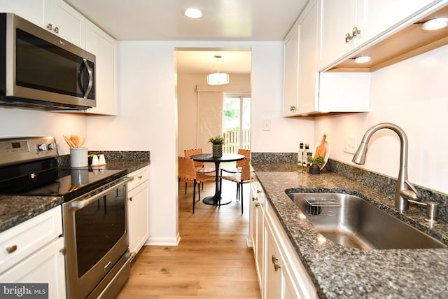 9835 Saint Cloud Ct, Fairfax, VA 22031 - kitchen with stainless steel appliances, light wood-style floors, white cabinets, recessed lighting, and dark stone countertops
