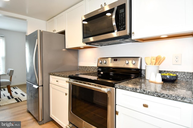9835 Saint Cloud Ct, Fairfax, VA 22031 - kitchen with stainless steel appliances, white cabinets, light wood-type flooring, and dark stone counters