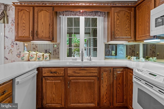 96 Karen Rd, Holland, PA 18966 - kitchen with white appliances, light countertops, brown cabinetry, and wallpapered walls