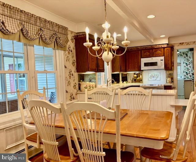 96 Karen Rd, Holland, PA 18966 - dining space featuring a chandelier, beamed ceiling, wood finished floors, and crown molding