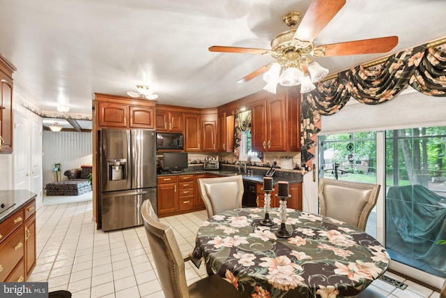 3851 Fawn Ln, White Plains, MD 20695 - kitchen with stainless steel refrigerator with ice dispenser, black microwave, dark countertops, a ceiling fan, and light tile patterned flooring
