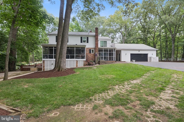 3851 Fawn Ln, White Plains, MD 20695 - traditional-style home featuring a sunroom, an attached garage, asphalt driveway, a chimney, and a front yard