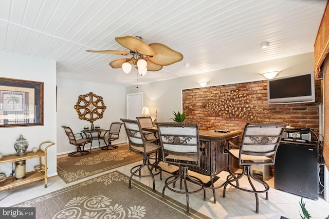 3851 Fawn Ln, White Plains, MD 20695 - dining room with light tile patterned floors, wood ceiling, ceiling fan, and brick wall