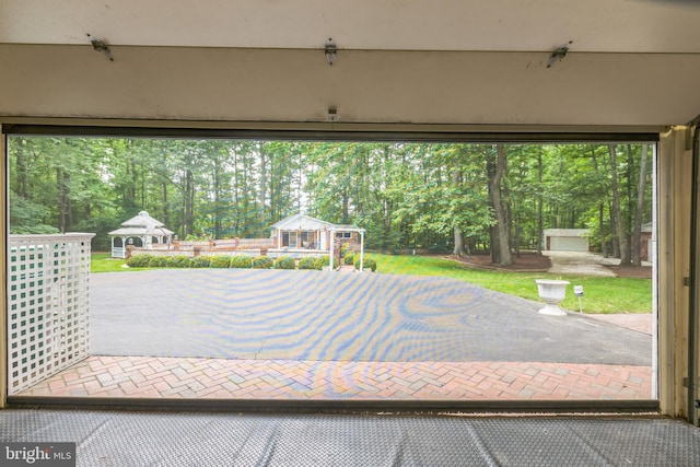 3851 Fawn Ln, White Plains, MD 20695 - view of patio / terrace featuring view of wooded area, an outdoor structure, and a gazebo