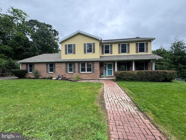 400 27th St, Huntingdon, PA 16652 - view of front of home featuring brick siding, a front yard, and a porch