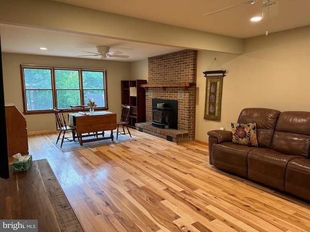 400 27th St, Huntingdon, PA 16652 - living room featuring ceiling fan, a wood stove, light wood-style floors, and recessed lighting