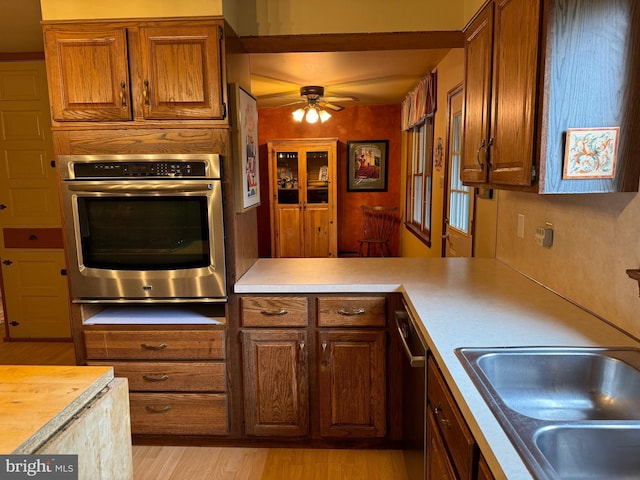 400 27th St, Huntingdon, PA 16652 - kitchen with appliances with stainless steel finishes, ceiling fan, light wood finished floors, and brown cabinets