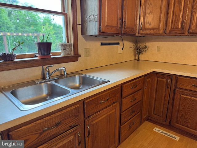 400 27th St, Huntingdon, PA 16652 - kitchen featuring light countertops, brown cabinetry, and light wood-style floors