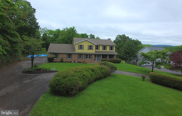 400 27th St, Huntingdon, PA 16652 - traditional-style home with driveway, a front lawn, and brick siding