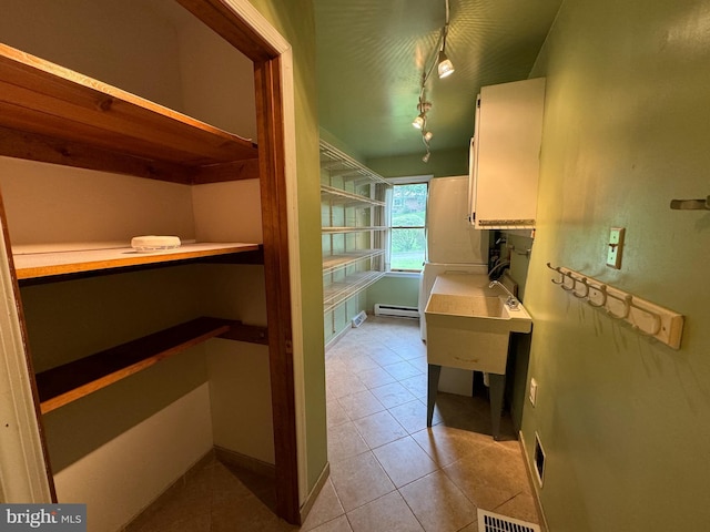 400 27th St, Huntingdon, PA 16652 - interior space featuring built in desk, a baseboard heating unit, and light tile patterned flooring