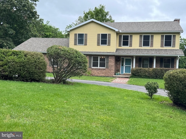 400 27th St, Huntingdon, PA 16652 - view of front of property featuring a front yard, brick siding, and roof with shingles