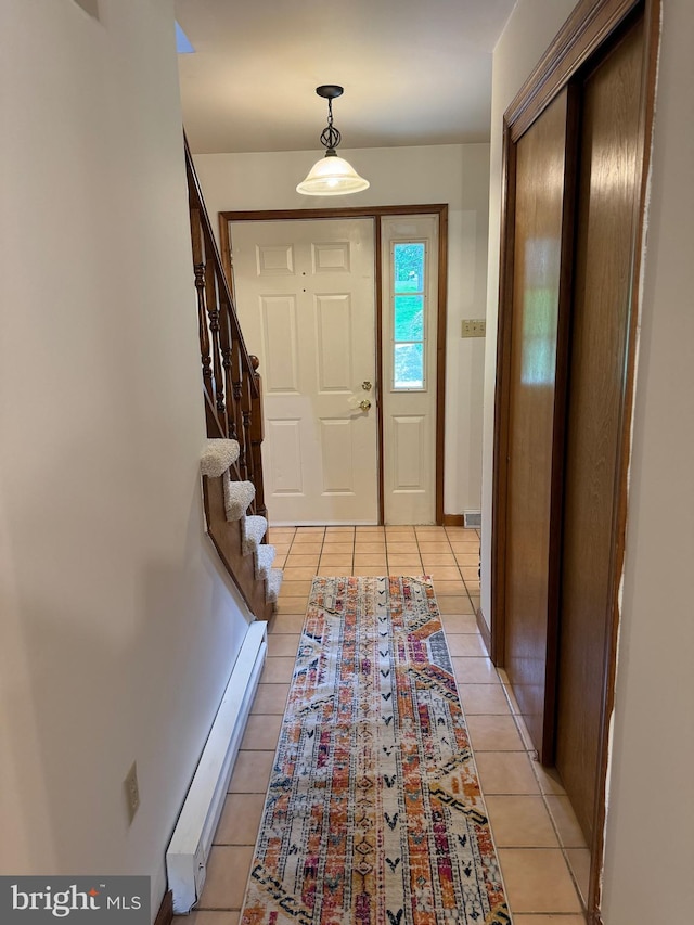 400 27th St, Huntingdon, PA 16652 - foyer entrance featuring a baseboard heating unit, light tile patterned floors, and stairs