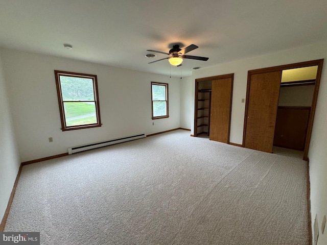 400 27th St, Huntingdon, PA 16652 - unfurnished bedroom featuring baseboard heating, multiple closets, carpet flooring, and a ceiling fan