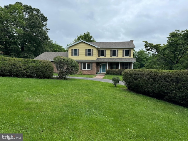 400 27th St, Huntingdon, PA 16652 - view of front of house with a front yard, covered porch, and brick siding