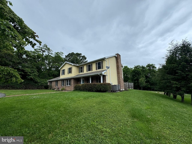 400 27th St, Huntingdon, PA 16652 - traditional-style house with a chimney, a front lawn, and brick siding