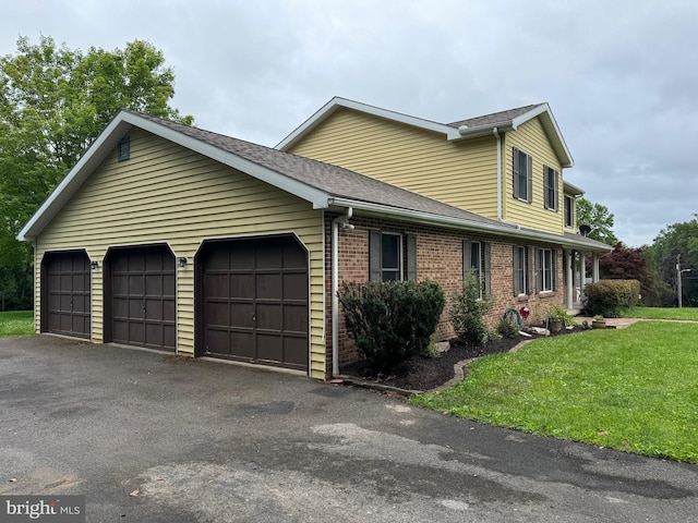 400 27th St, Huntingdon, PA 16652 - view of front of home featuring an attached garage, a front yard, a shingled roof, brick siding, and asphalt driveway