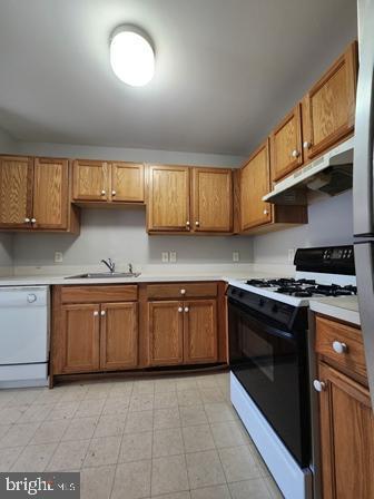 337 Nicholas Dr, Riverside, NJ 08075 - kitchen featuring dishwasher, range with gas cooktop, under cabinet range hood, and brown cabinetry