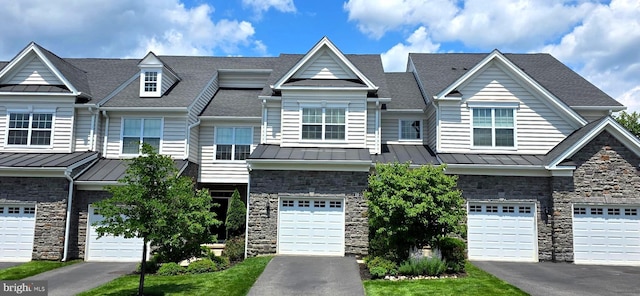 210 Ella Ln, Conshohocken, PA 19428 - multi unit property with a standing seam roof, stone siding, a metal roof, an attached garage, and a shingled roof