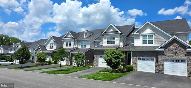 210 Ella Ln, Conshohocken, PA 19428 - townhome / multi-family property featuring stone siding, a residential view, a standing seam roof, driveway, and an attached garage