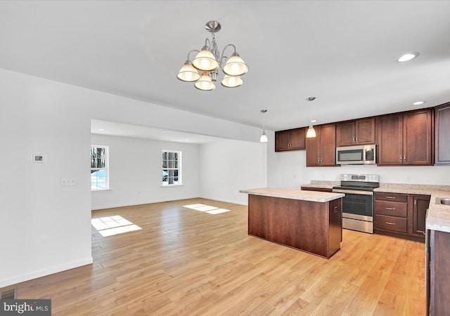 21 American Ave, Carlisle, PA 17013 - kitchen featuring appliances with stainless steel finishes, a kitchen island, a chandelier, pendant lighting, and recessed lighting