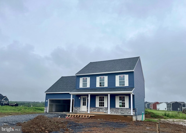 21 American Ave, Carlisle, PA 17013 - view of front facade featuring a porch, an attached garage, stone siding, dirt driveway, and a shingled roof