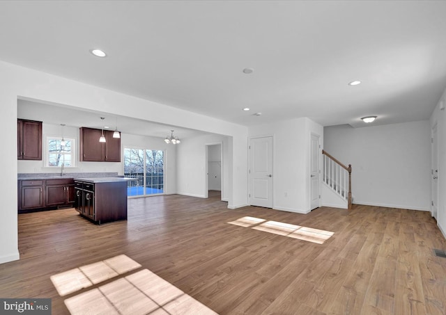 21 American Ave, Carlisle, PA 17013 - unfurnished living room featuring a chandelier, light wood-style floors, stairs, and recessed lighting
