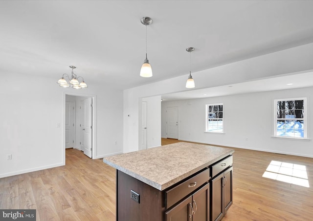 21 American Ave, Carlisle, PA 17013 - kitchen featuring light countertops, light wood-style flooring, a chandelier, decorative light fixtures, and dark brown cabinetry