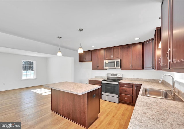 21 American Ave, Carlisle, PA 17013 - kitchen with appliances with stainless steel finishes, light countertops, a kitchen island, light wood-style flooring, and hanging light fixtures