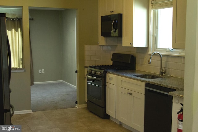 161 Carlton Ave, Marlton, NJ 08053 - kitchen with black appliances, tasteful backsplash, dark stone counters, light carpet, and white cabinetry