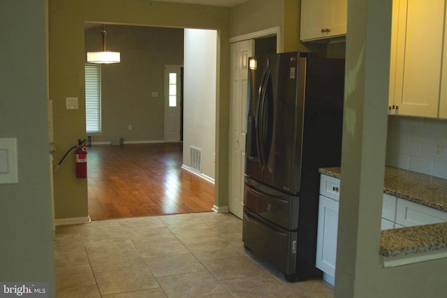 161 Carlton Ave, Marlton, NJ 08053 - kitchen featuring refrigerator with ice dispenser, white cabinetry, stone countertops, backsplash, and light tile patterned floors