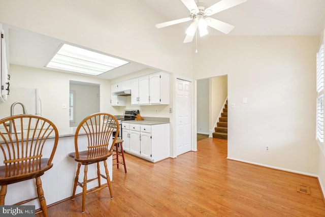 13 Gelding Ct, Olney, MD 20832 - kitchen featuring stainless steel electric range, freestanding refrigerator, white cabinetry, under cabinet range hood, and light wood-style floors