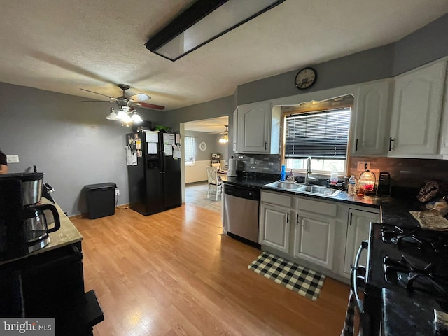 1105 Darlington Rd, Beaver Falls, PA 15010 - kitchen with black appliances, ceiling fan, backsplash, white cabinets, and light wood-type flooring