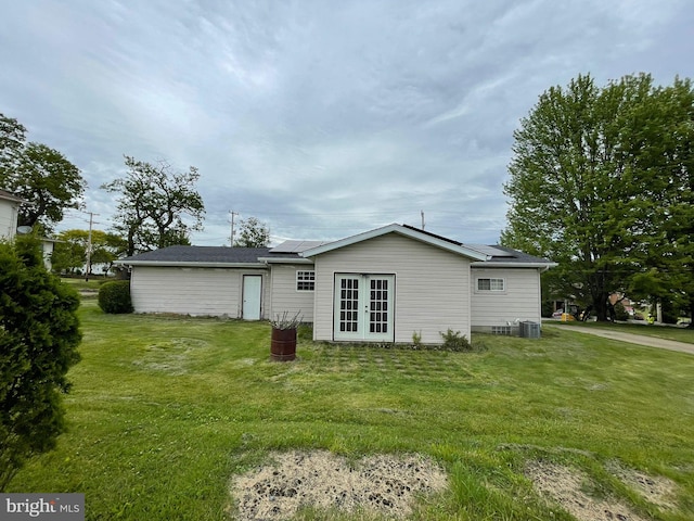 1105 Darlington Rd, Beaver Falls, PA 15010 - rear view of property featuring french doors, roof mounted solar panels, and a lawn