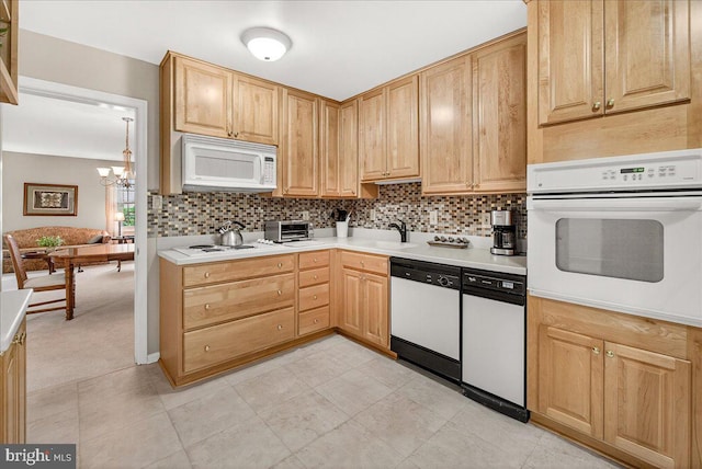 7504 Westlake Ter Unit 25, Bethesda, MD 20817 - kitchen with white appliances, light countertops, backsplash, a chandelier, and light brown cabinets