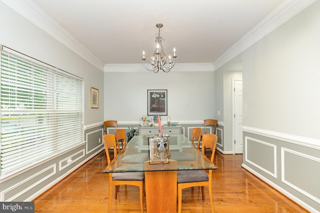 1404 Preserve Ln, Fredericksburg, VA 22401 - dining space featuring crown molding, a chandelier, light wood-style floors, wainscoting, and a decorative wall