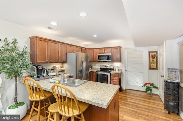 1404 Preserve Ln, Fredericksburg, VA 22401 - kitchen with appliances with stainless steel finishes, a peninsula, light countertops, light wood finished floors, and recessed lighting