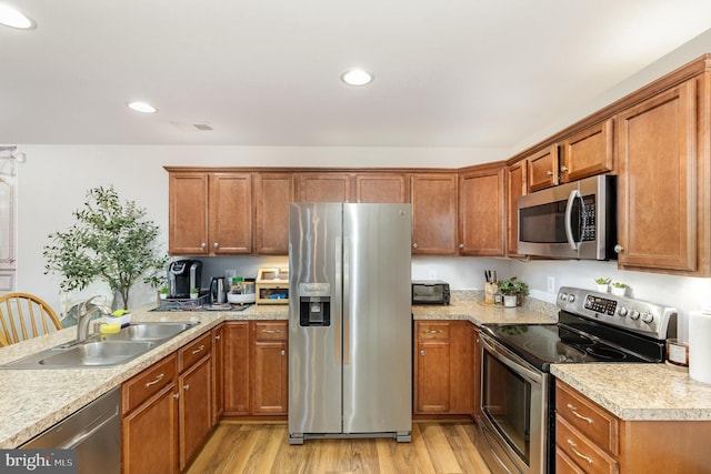 1404 Preserve Ln, Fredericksburg, VA 22401 - kitchen with appliances with stainless steel finishes, light countertops, light wood finished floors, brown cabinets, and recessed lighting