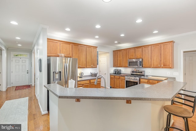 1404 Preserve Ln, Fredericksburg, VA 22401 - kitchen featuring stainless steel appliances, crown molding, a kitchen bar, light wood finished floors, and recessed lighting