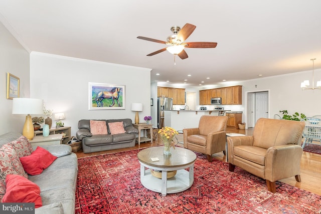 1404 Preserve Ln, Fredericksburg, VA 22401 - living room featuring ceiling fan, a chandelier, ornamental molding, recessed lighting, and light wood finished floors