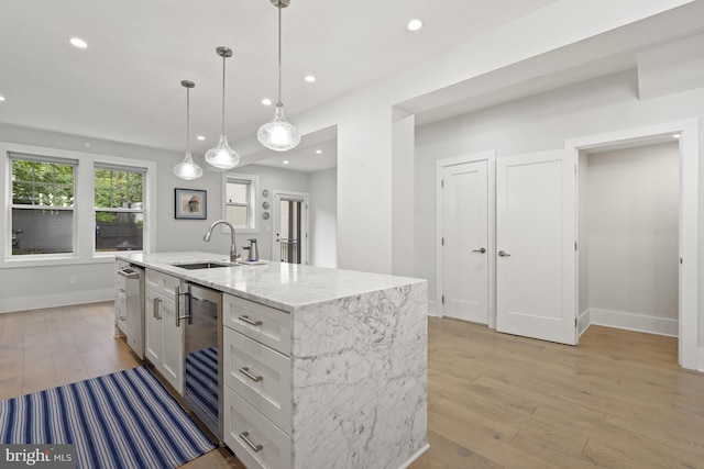 2819 Bellevue Ter NW, Washington, DC 20007 - kitchen featuring beverage cooler, light wood-style flooring, white cabinets, light stone counters, and pendant lighting