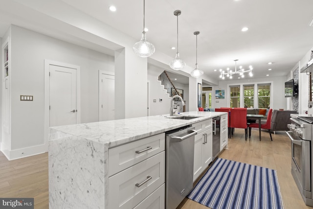 2819 Bellevue Ter NW, Washington, DC 20007 - kitchen with appliances with stainless steel finishes, light wood-style floors, white cabinetry, recessed lighting, and a chandelier