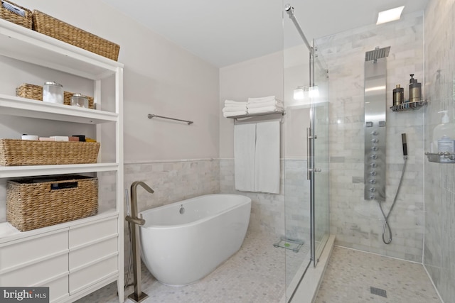 2819 Bellevue Ter NW, Washington, DC 20007 - bathroom featuring a stall shower, a freestanding bath, wainscoting, and tile walls