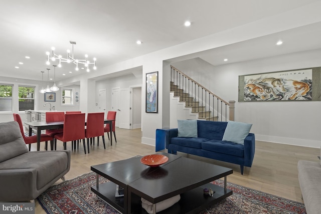 2819 Bellevue Ter NW, Washington, DC 20007 - living room with a chandelier, recessed lighting, light wood-style floors, and stairs