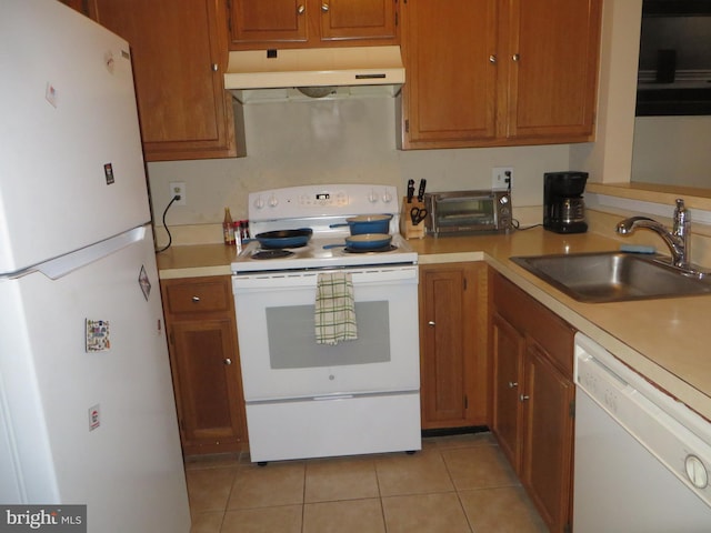 6915 Victoria Dr Unit C, Alexandria, VA 22310 - kitchen with white appliances, under cabinet range hood, light tile patterned floors, light countertops, and brown cabinetry