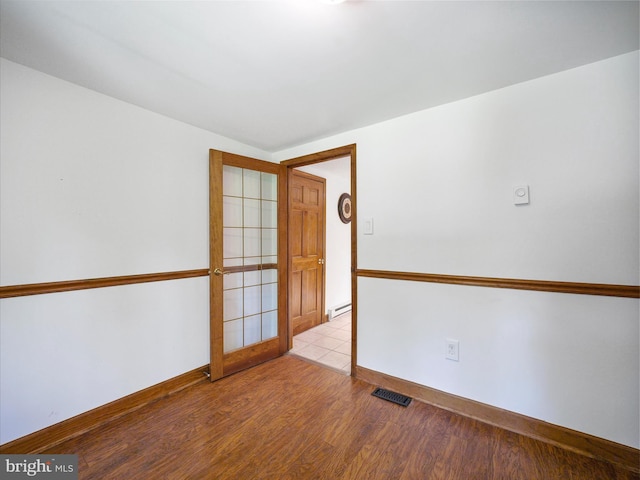 258 Merrimack, Falling Waters, WV 25419 - spare room with wood finished floors and a baseboard radiator