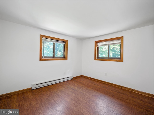 258 Merrimack, Falling Waters, WV 25419 - empty room with baseboard heating, wood finished floors, and healthy amount of natural light