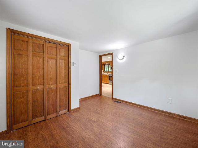 258 Merrimack, Falling Waters, WV 25419 - unfurnished bedroom featuring wood finished floors and a closet