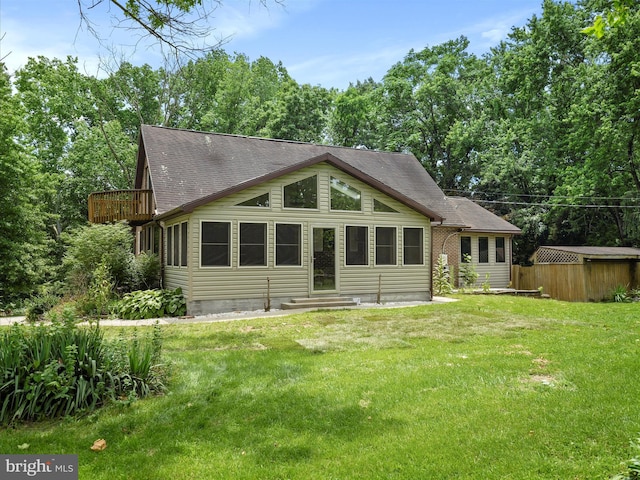 258 Merrimack, Falling Waters, WV 25419 - rear view of house with entry steps, a shingled roof, a yard, and a balcony